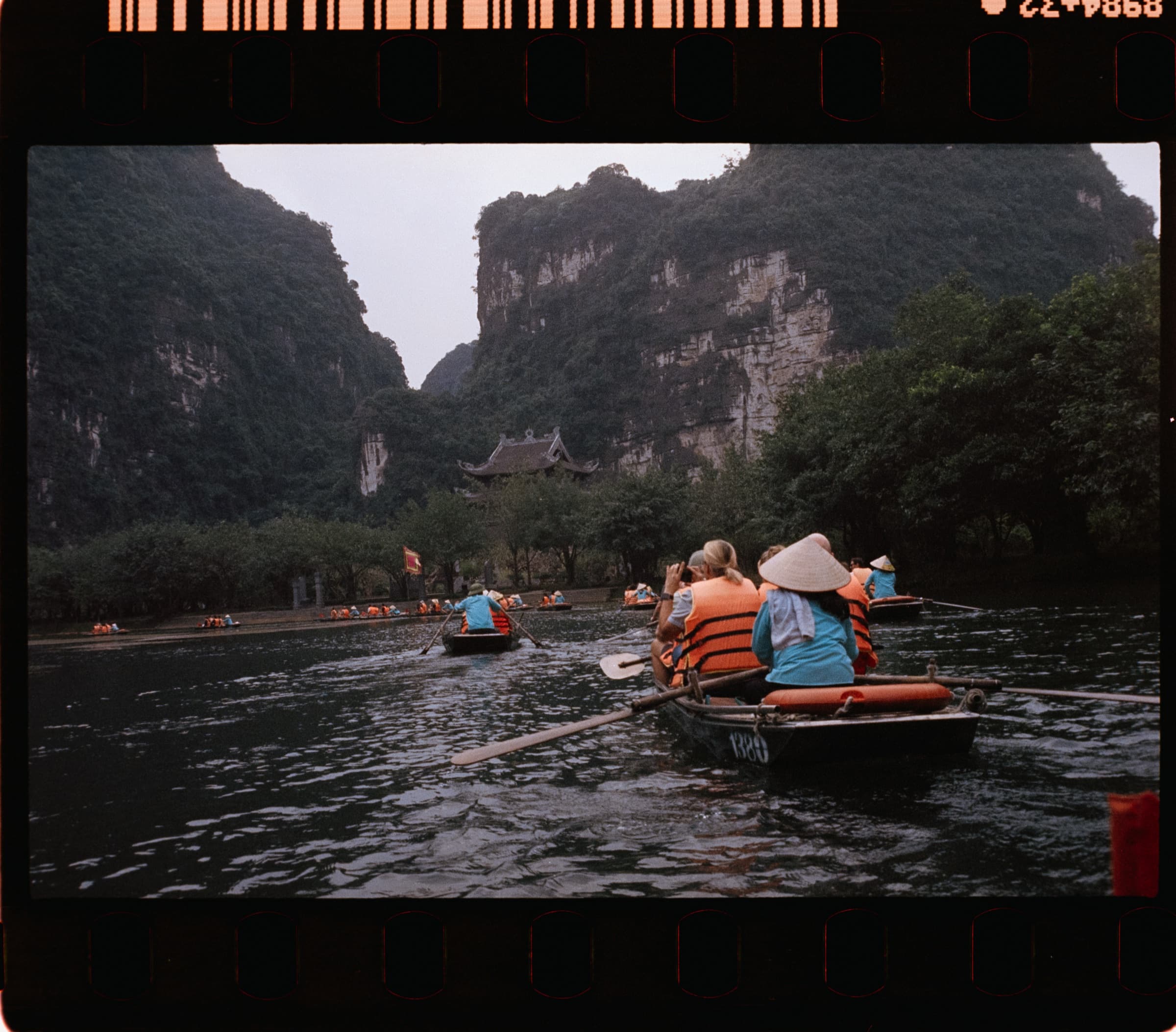 Boats and passengers beneath karst peaks, Ninh Binh