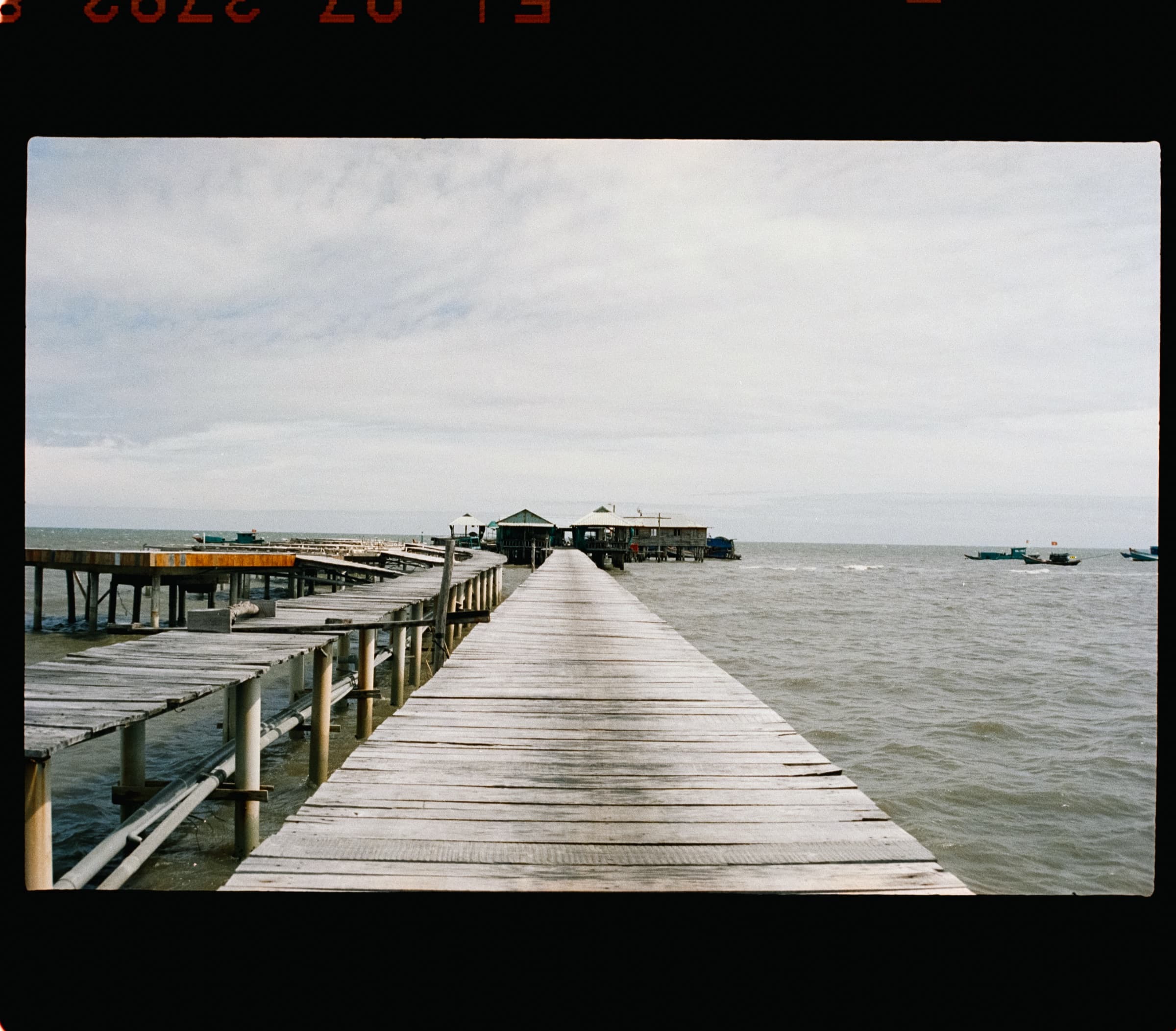 A wooden pier reaching into calm water, Phu Quoc